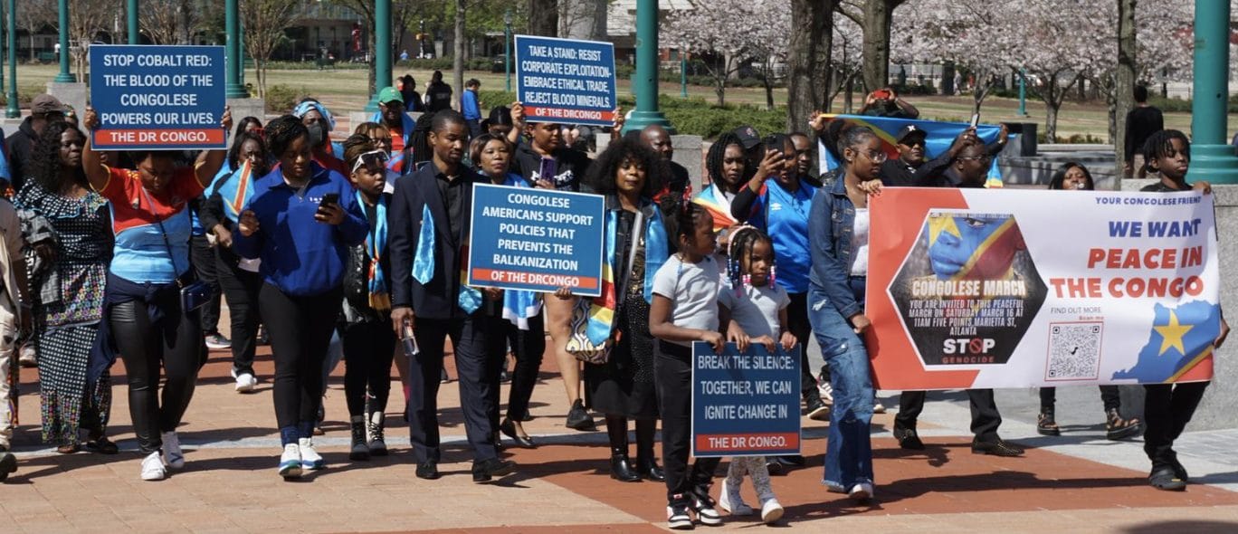 Image of a few dozen protestors demonstrating for peace in Congo.